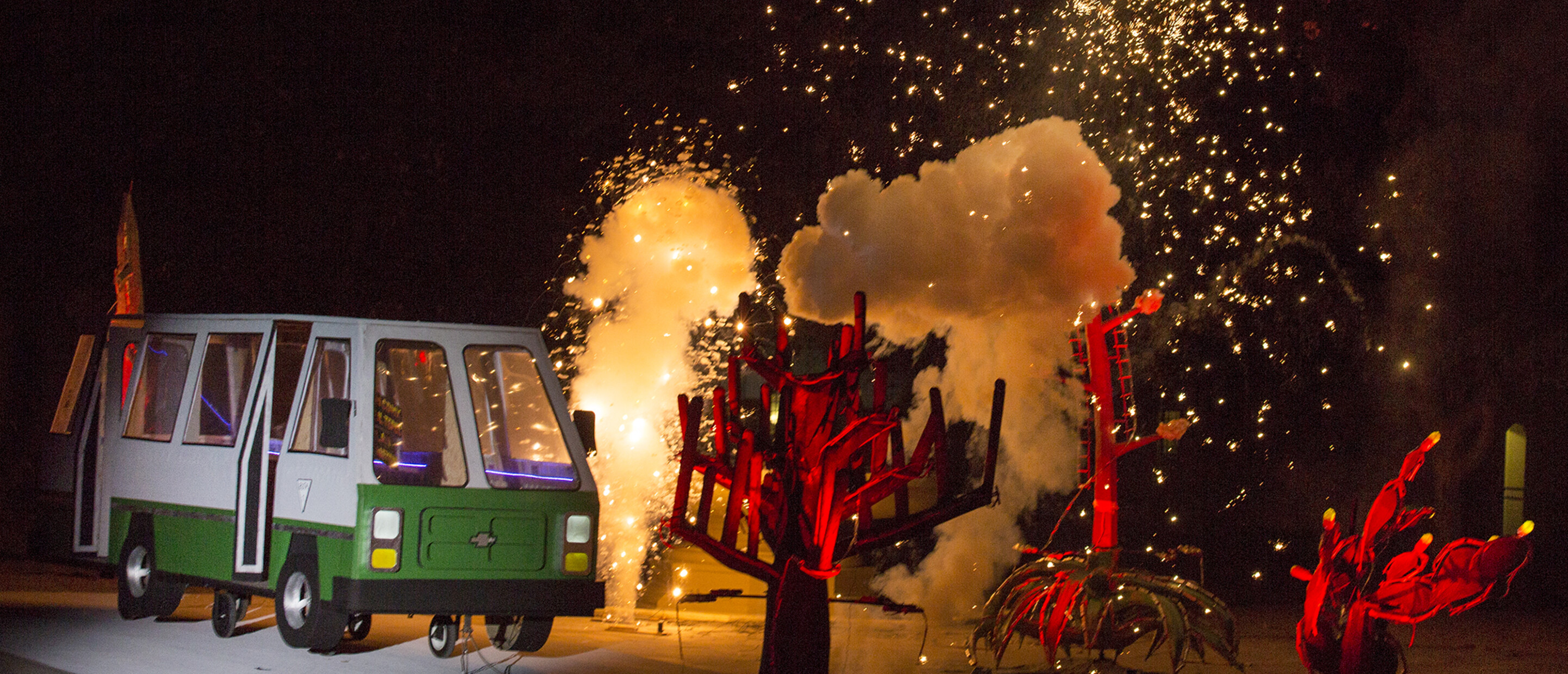 Papermaché microbus and cacti being blown up using pyrotechnics