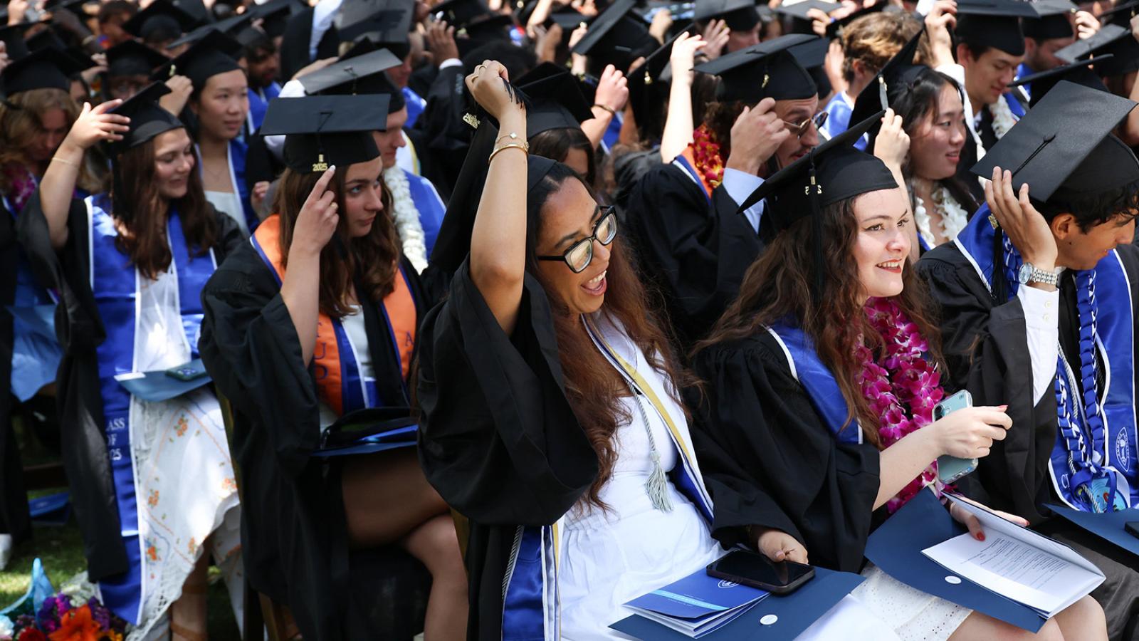 Class of 2025 members move their tassels over during Commencement exercises.