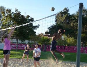 students playing sand volleyball